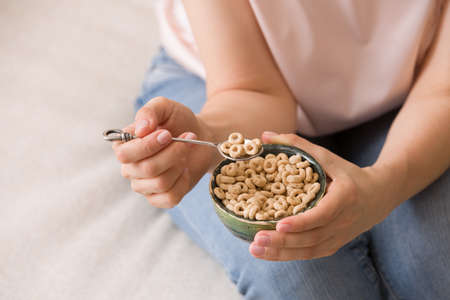 Closeup of woman's hands holding bowl with organic whole wheat cereal.  Healthy food and eating. Healthy Breakfast or snack.の写真素材