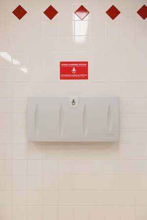 Baby diaper table in a public restroom. Child changing board in a toilet.の写真素材
