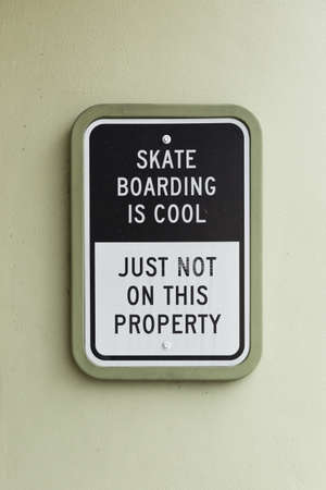 Skateboarding is cool but not here sign. an exterior sign