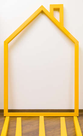 Yellow frame of children wooden house. assembling child toy house.の写真素材