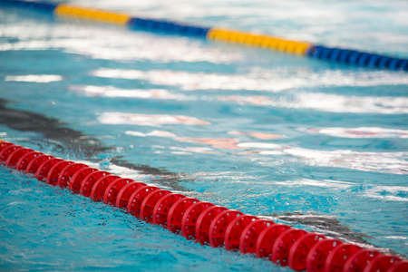 The view of an empty public swimming pool indoors. Lanes of a competition swimming pool. Sport conceptの写真素材