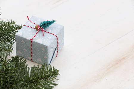Packing Christmas gifts box on white wooden table. Top view with copy spaceの写真素材