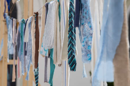 Colorful ribbons and pieces of fabric on the rope.の写真素材