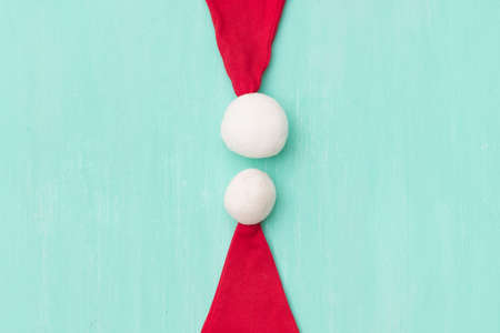 Santa's hats on wooden turquoise background or table. Closeup. Christmas, New Year, holidays and...