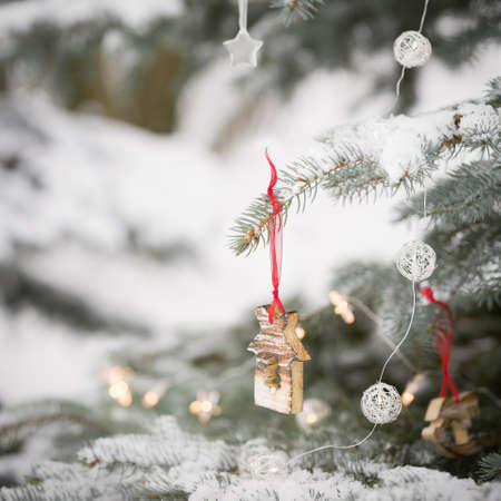 Close up of snowy Christmas tree with nice decorations in the forest. Winter, Christmas celebration, holidays season.の写真素材