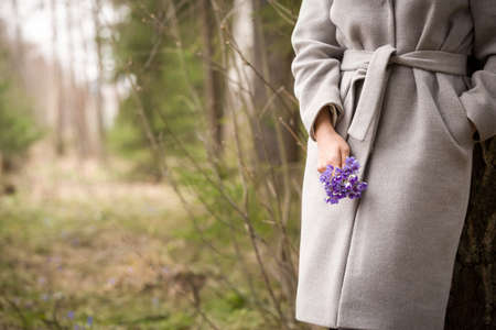 Closeup of woman's hands holding bunch of fresh wild snowdrops. spring flowers in girl's hands.の写真素材