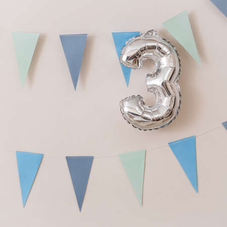 The ball in the form of numbers 3 and a garland of blue flags. Birthday decorationsの写真素材
