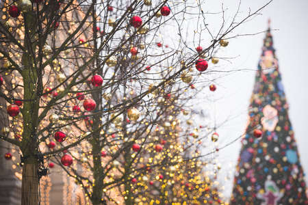 Christmas holiday decor in the center of Moscow. Christmas toys hang on the branches of a tree, and...