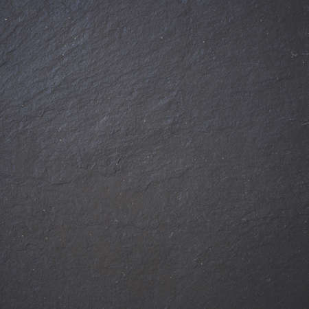 Black stone background texture. Top view on a solid embossed surface. Copy spaceの写真素材