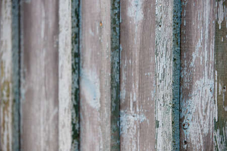 Closeup of an old texture of a weathered wooden wall painted in turquoise color. Aged wooden plank fence. Copy space. Selective focusの写真素材