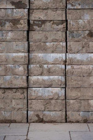 The paving stone is folded in several rows. Dismantled dirty tile lies on the sidewalk. Repair work....