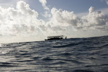 Dhoni boat in the Indian ocean on sunset time.の写真素材