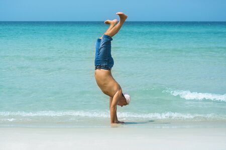 The man have a fun time on the tropical beachの写真素材