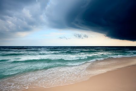Sandy beach and dramatic sky landscapeの写真素材