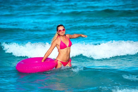 Woman with raft on the tropical beachの写真素材