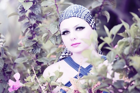 Young woman with creative make-up at flower gardenの写真素材