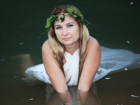 Beautiful woman as a forest nymph on the riverの写真素材