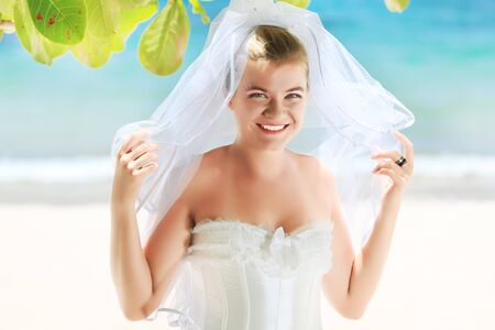 Beautiful young  bride on the tropical beachの写真素材