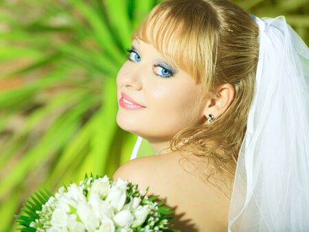Beautiful young bride in wedding dress outdoorの写真素材