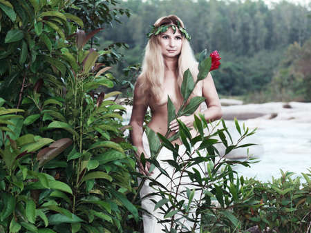 Beautiful woman as a forest nymph on the riverの写真素材