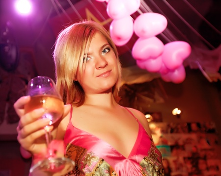 Young woman with glass of wine at partyの写真素材