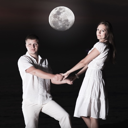 Couple at sunrise time. Ocean on backgroundの写真素材