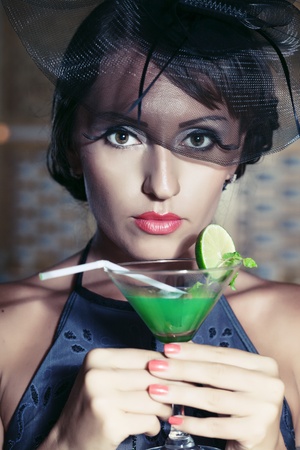 Fashion woman retro portrait with a cocktailの写真素材