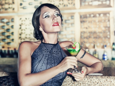 Fashion woman retro portrait with a cocktailの写真素材