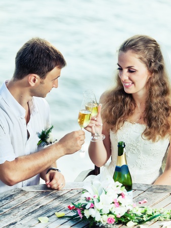 Bride and groom at wedding table near the seaの写真素材
