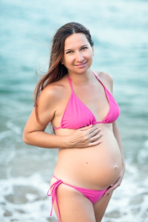 Beautiful pregnant woman on the beachの写真素材