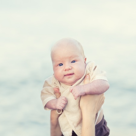Human hands are holding adorable babyの写真素材