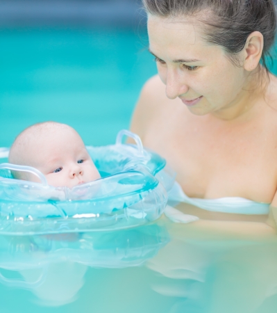 Baby and mom in swimming poolの写真素材