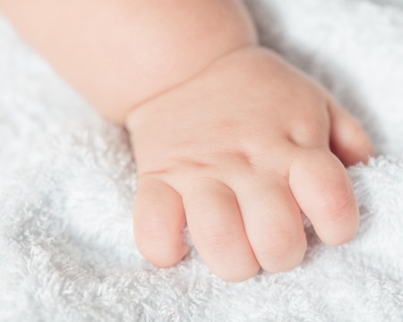 Hand of a baby on terry 