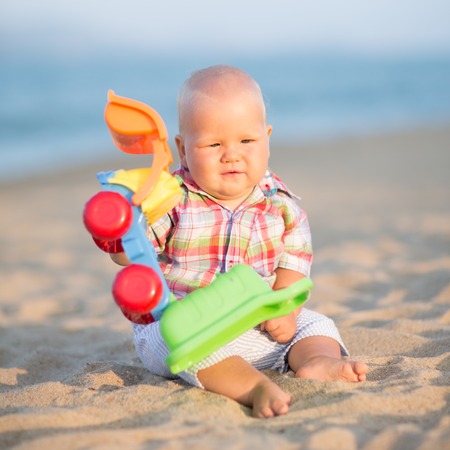 Cute baby is playing toy car