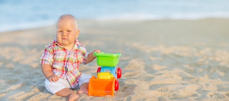 Cute baby is playing toy carの写真素材