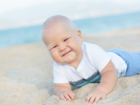 Cute baby on the tropical beachの写真素材