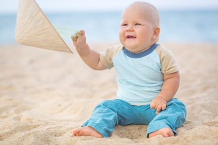 Cute baby on the tropical beachの写真素材