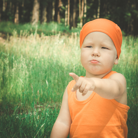 Outdoor portrait of the cute baby pointingの写真素材