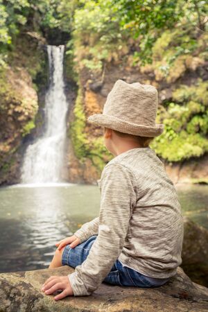 Child looking Chamouze waterfall. Mauritius islandの写真素材