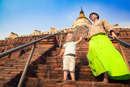 Child and Mom climbing on Buddhist pagoda Shwesandaw in Bagan. Myanmarの写真素材