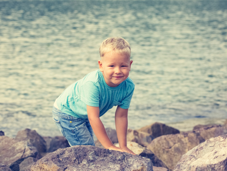 Cute caucasian boy at seaside. Leisure timeの写真素材