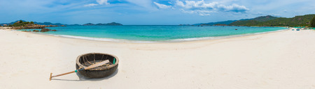 Beautiful white sand beach. Vietnamese round boat on a foreground. Beautiful landscape of Vietnam. Panoramaの写真素材