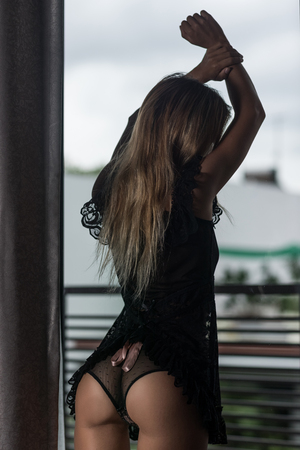 Beautiful woman posing at the windowの写真素材