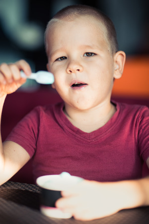 Portrait of a cute boy eating ice cream.の写真素材
