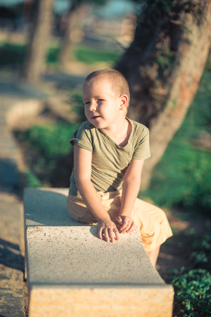 Outdoor portrait of cute little smiling boyの写真素材