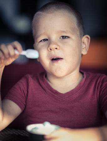 Portrait of a cute boy eating ice cream.の写真素材