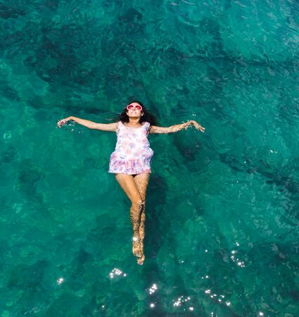 Aerial view of a beautiful woman dancing  in the sea