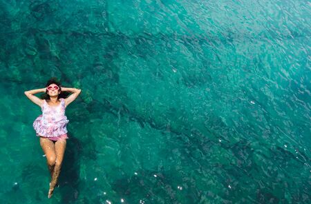 Aerial view of a beautiful woman dancing  in the seaの写真素材