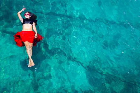 Aerial view of a beautiful woman dancing  in the seaの写真素材