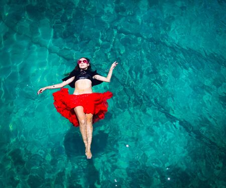 Aerial view of a beautiful woman dancing  in the seaの写真素材